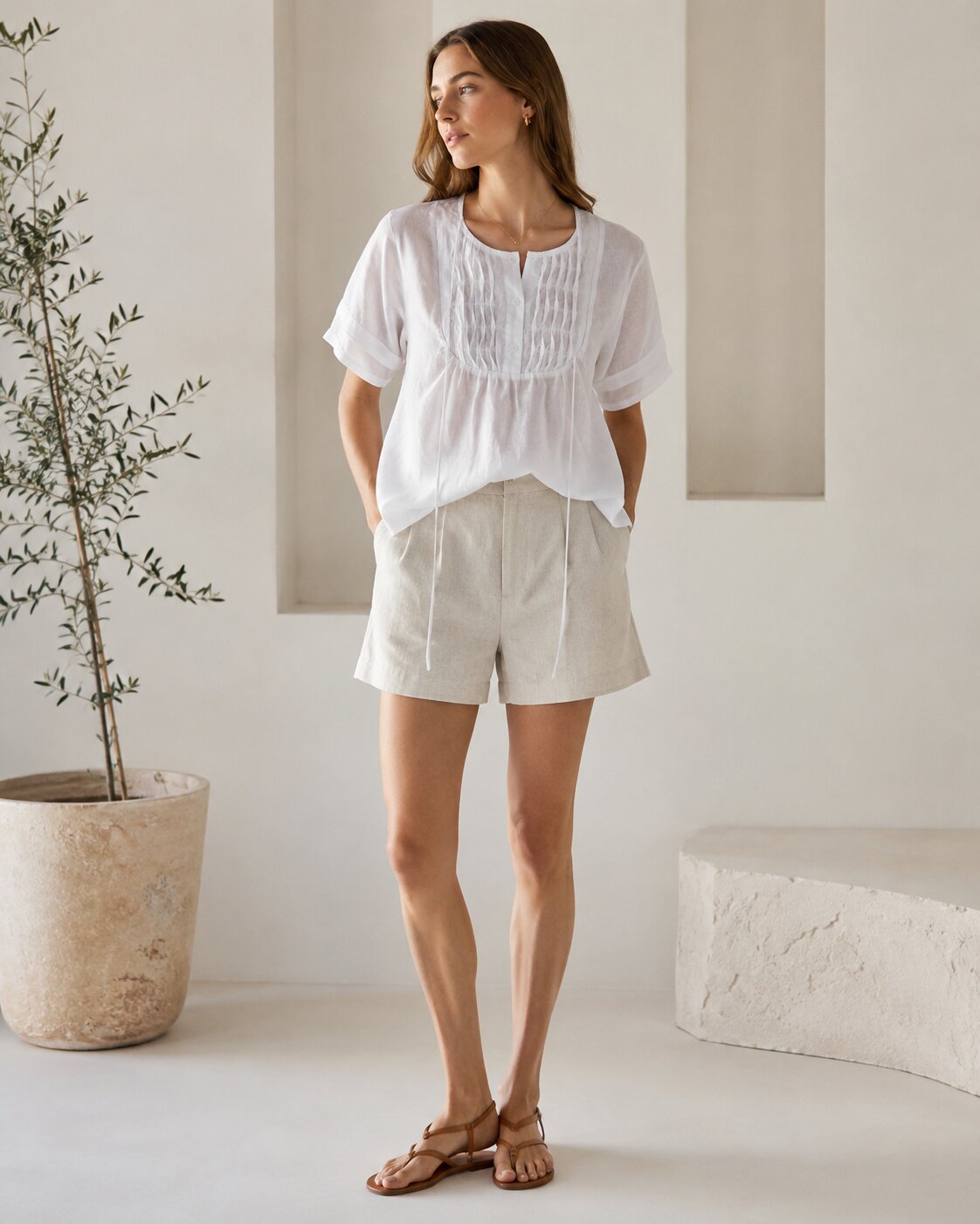 White short-sleeve pintuck blouse with light shorts