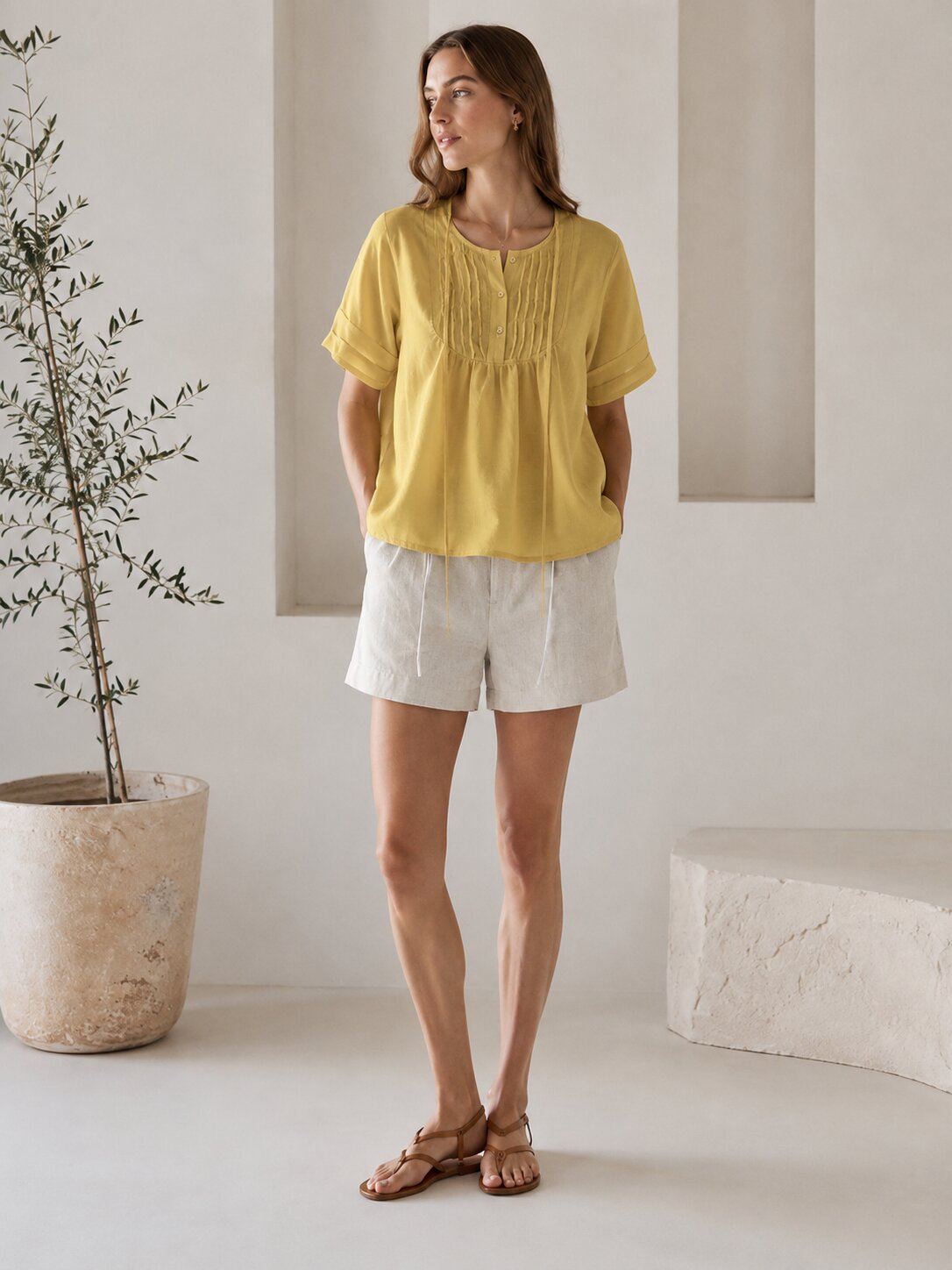 Yellow pintuck blouse styled with light shorts