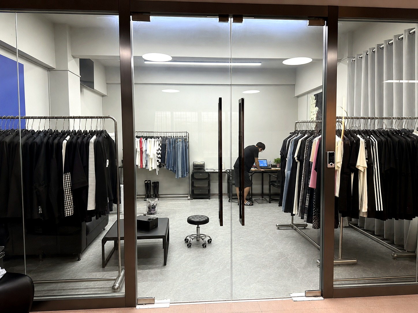 UP NANQING showroom entrance with clothing samples and garment racks